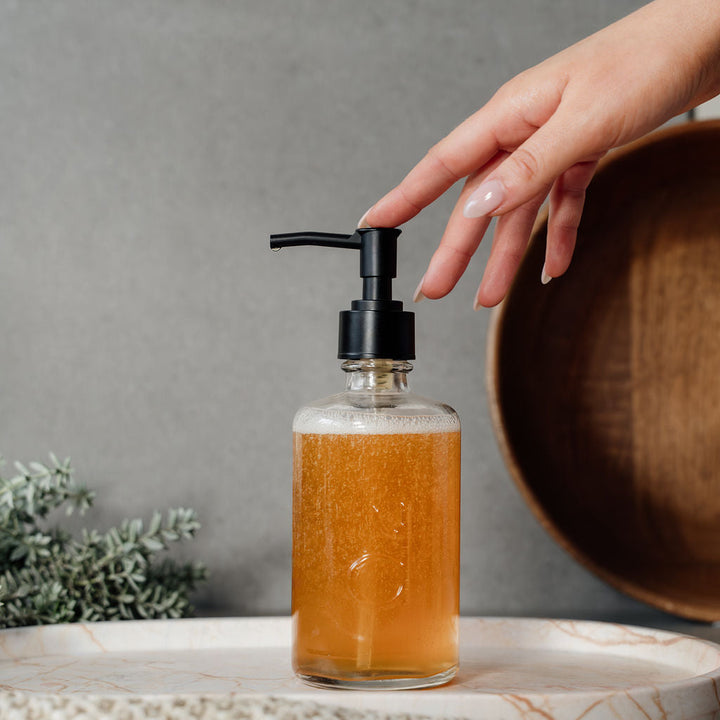 dindi glass bottle with hand touching